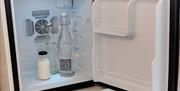 All 6 rooms have wine bottle size fridges, we supply water and milk in reusable glass bottles.